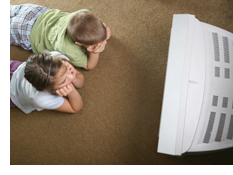 Photo of two children watching television